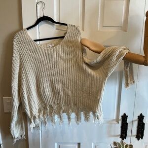 Fun fringe cropped sweater in a light creamy beige